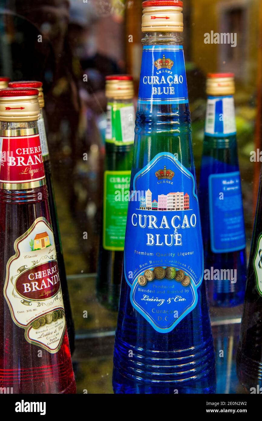 Bottles of Curacao liqueur liquor alcohol in the craft market