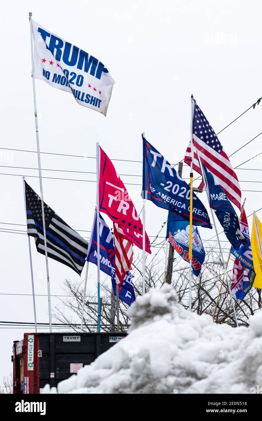 Collection of pro-Trump flags seen on cold snowy day several weeks after Donald Trump's loss in the 2020 General Election Stock Photo