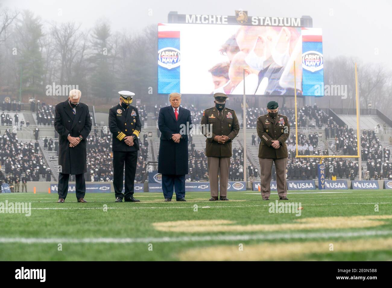 President Donald J. Trump, joined by acting Secretary of Defense Christopher C. Miller, Chairman of the Joint Chiefs of Staff Gen. Mark A. Milley, and senior military officials, bows his head during the reading of the invocation before the start of the 121st Army-Navy football game Saturday, Dec. 12, 2020, at Michie Stadium at the United States Military Academy at West Point, N.Y. People: President Donald Trump Credit: Storms Media Group/Alamy Live News Stock Photo