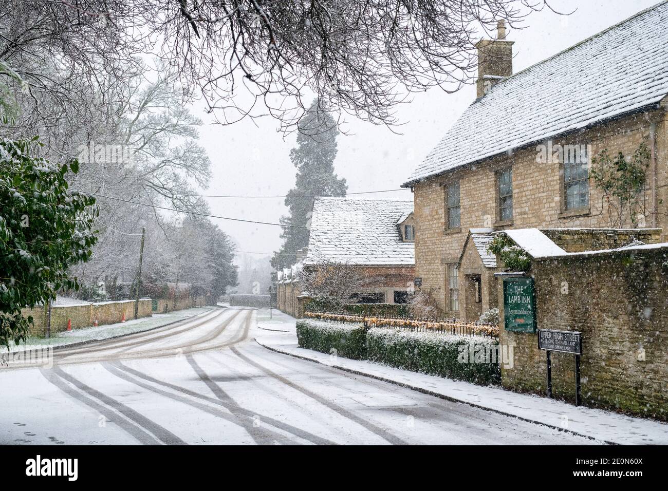 Shipton Under Wychwood high street in the snow at christmas. Shipton