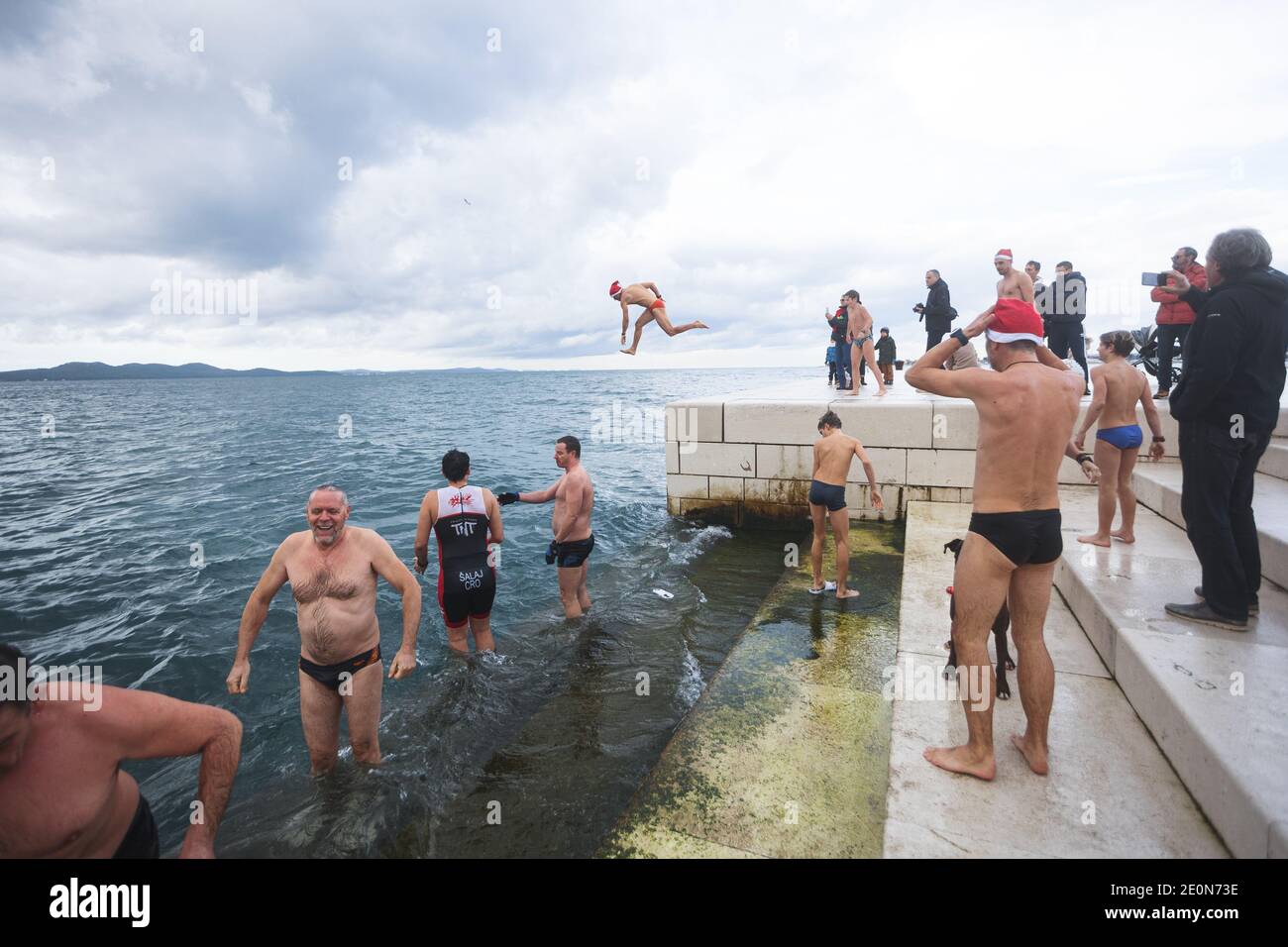 (210102) -- ZADAR, Jan. 2, 2021 (Xinhua) -- A man jumps into the sea to celebrate the New Year in Zadar, Croatia, Jan. 1, 2021. (Marko Dimic/Pixsell via Xinhua) Stock Photo