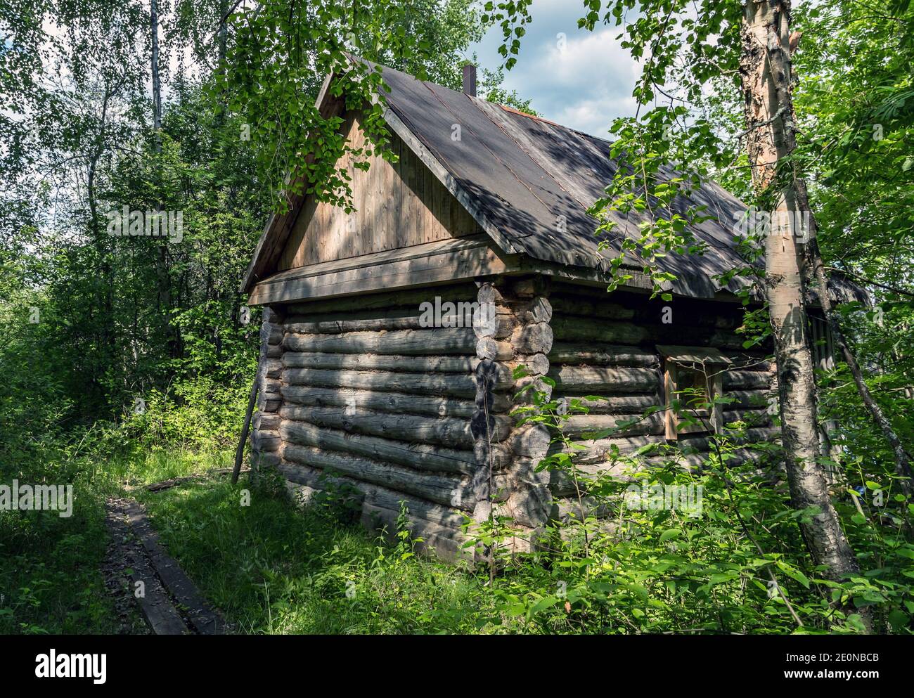 Weathered exterior wooden sauna of ancient log cabin shelter in the