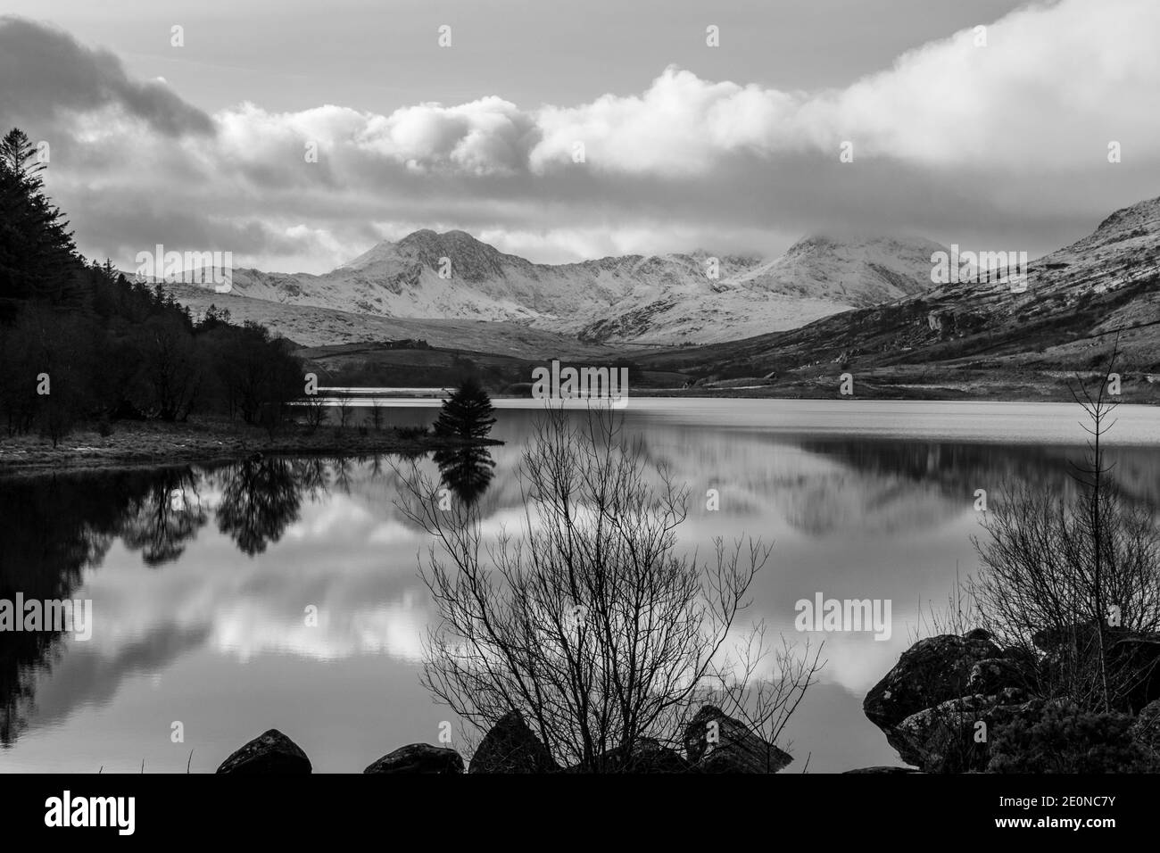 Looking down Llynnau Mymbyr lake from Capel Curig towards Snowdon. This lake is situated in the Snowdonia National Park in North Wales. Stock Photo