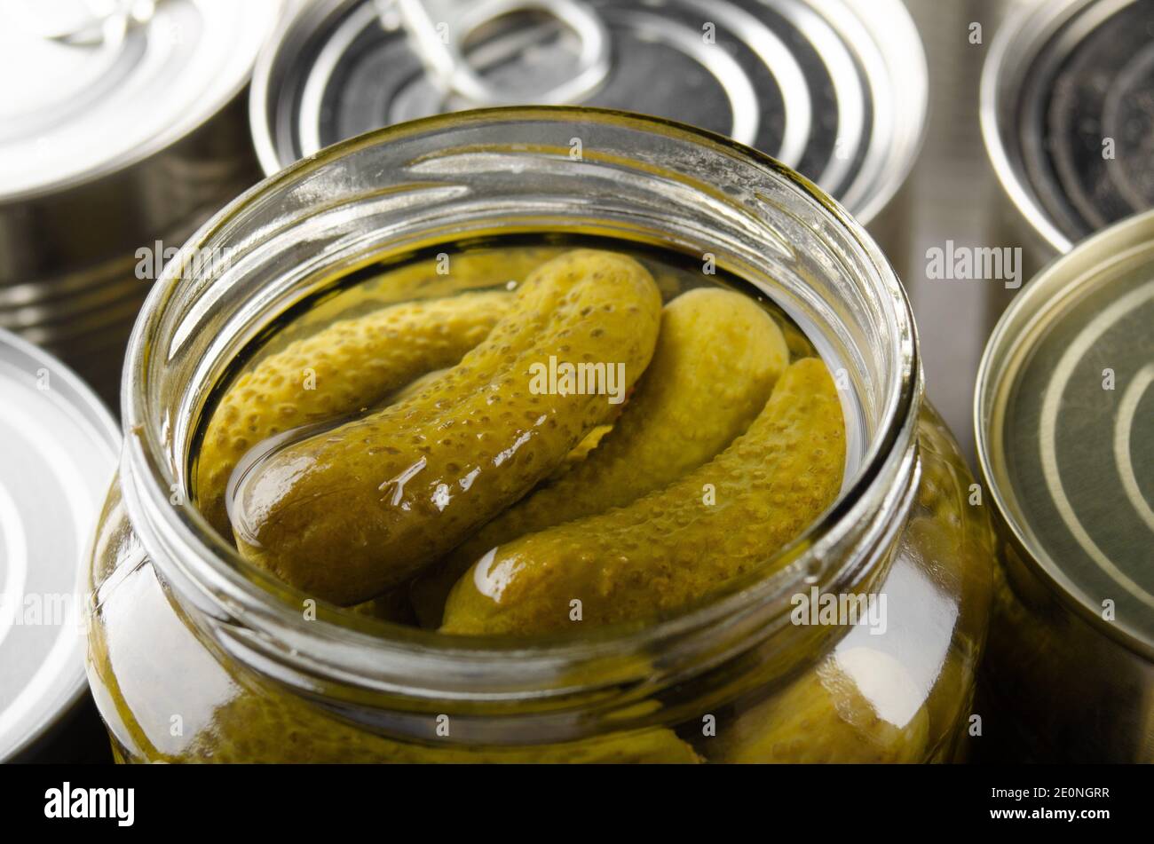 Canned pickles in just opened glass mason jar. Nonperishable food