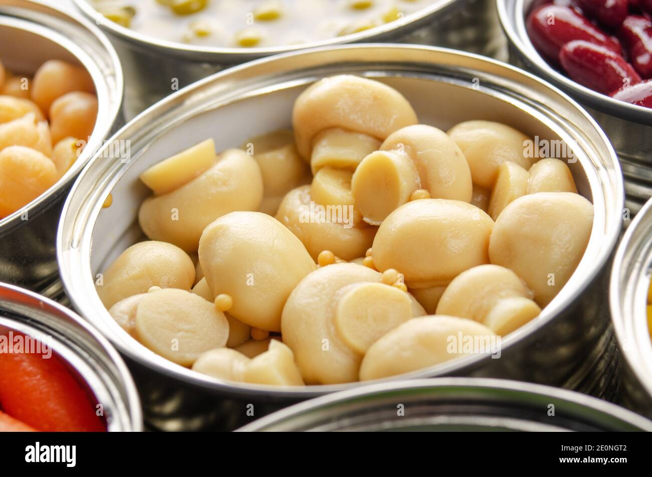 Canned button mushrooms in just opened tin can. Nonperishable food