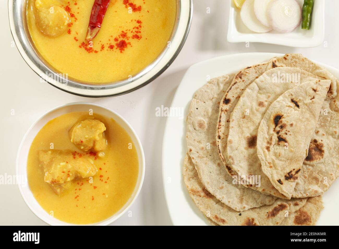 Indian Food: Kadhi with gatte, puri, chapati, ready to eat. Stock Photo