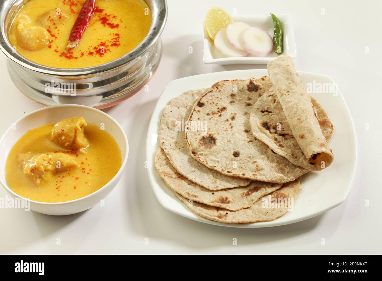 Indian Food: Kadhi with gatte, puri, chapati, ready to eat. Stock Photo