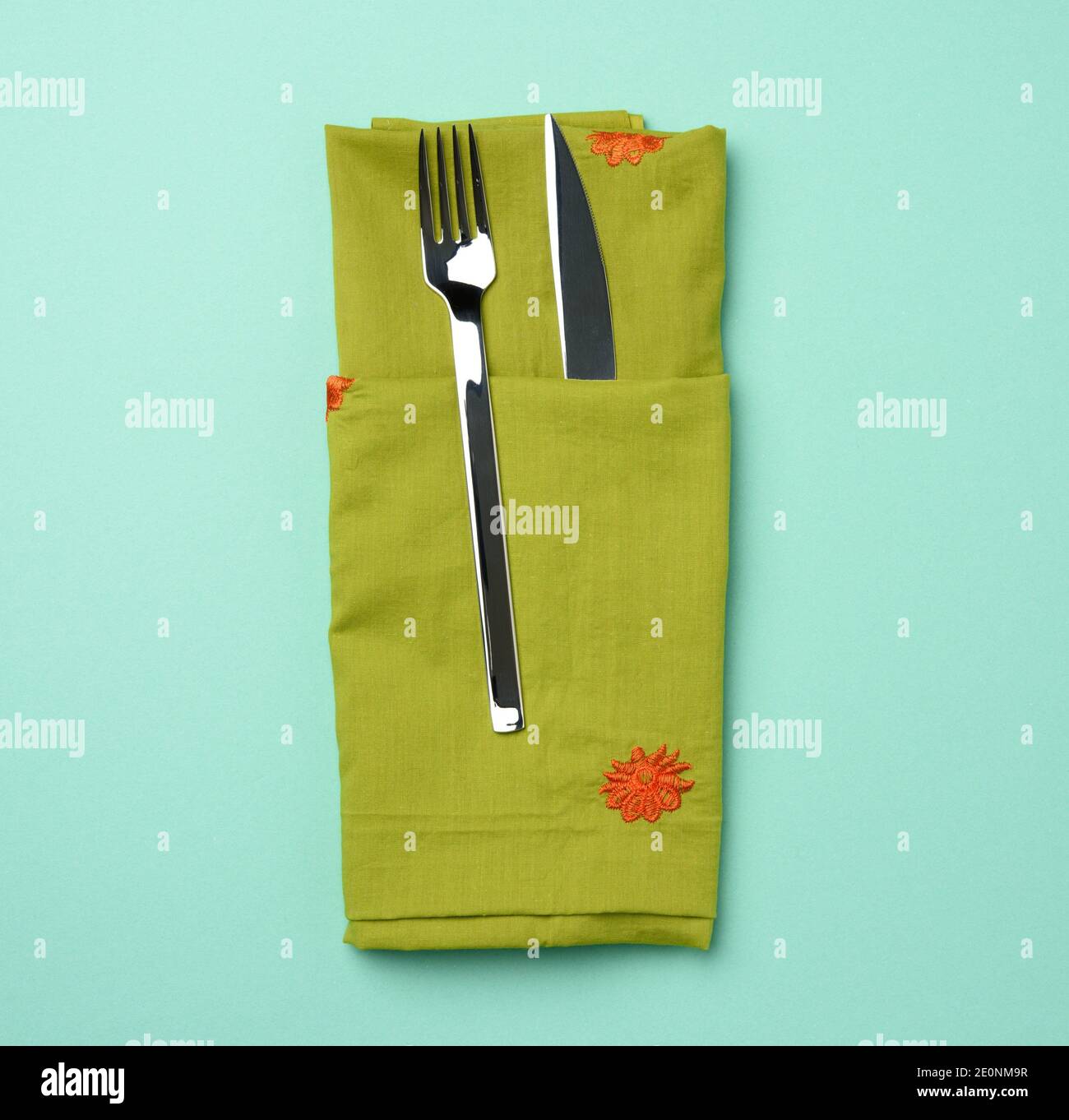 metal fork and knife, green background, top view Stock Photo Alamy