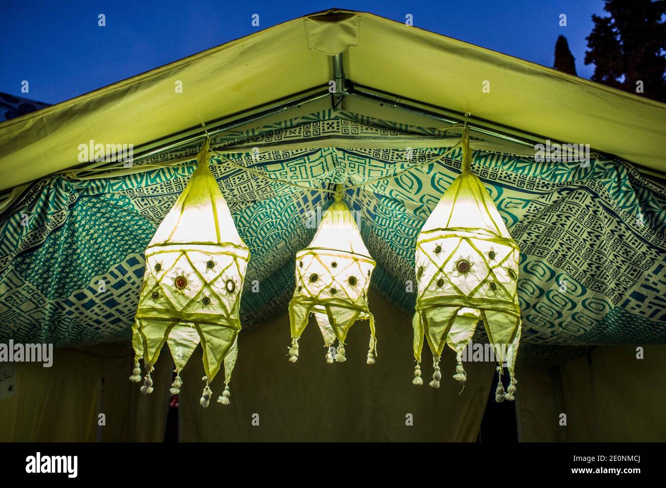 Oriental fabric lanterns inside a tent entry. Dusk background. Stock Photo