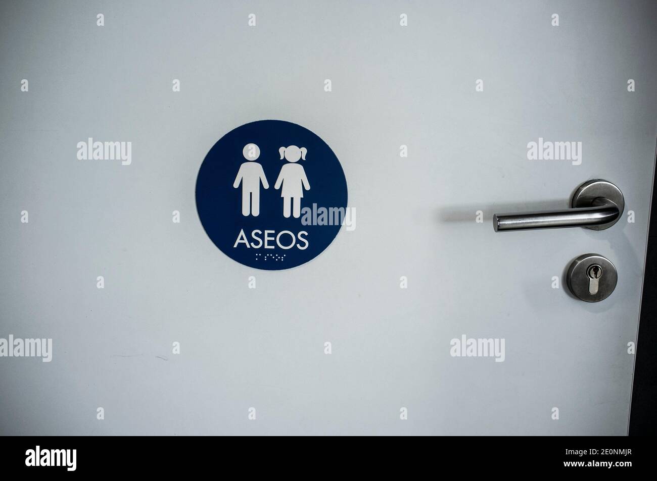 Door decal for children toilet. Sticker placed at eye-level with text caption in braille language. Stock Photo