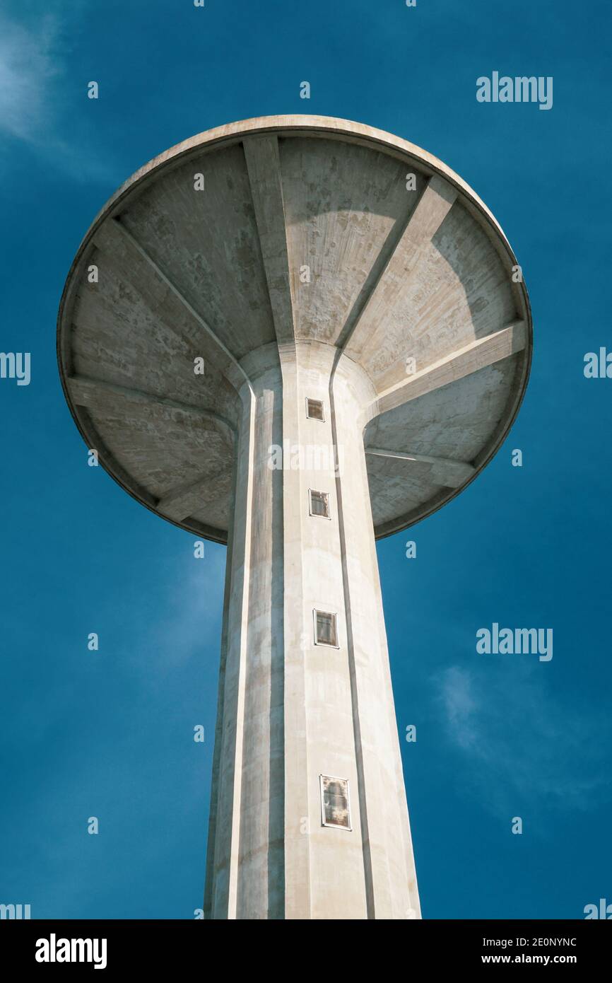 Mortara - 12/31/2020: tower of the aqueduct against blue sky, brutalist architecture Stock Photo