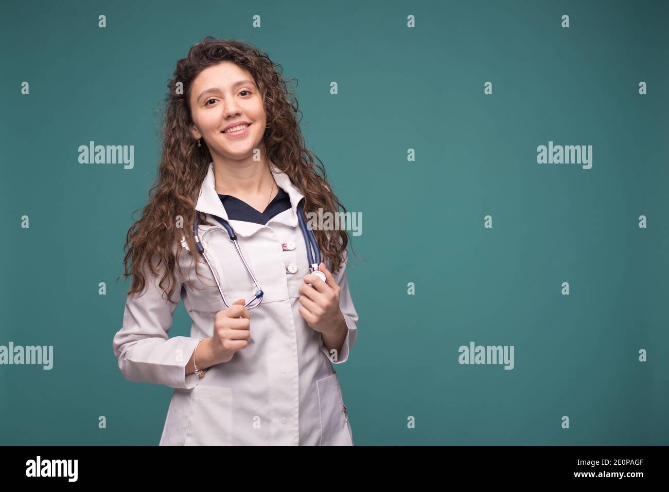 Female medical doctor in white professional uniform with stethoscope on ...