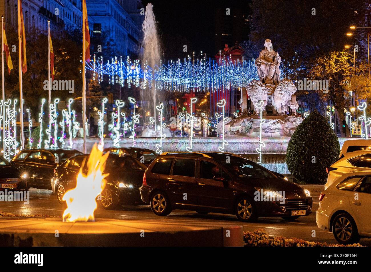 Christmas decoration at the Cibeles Fountain and permanent fire flame for the victims of Covid-19, MADRID, SPAIN, EUROPE. Stock Photo