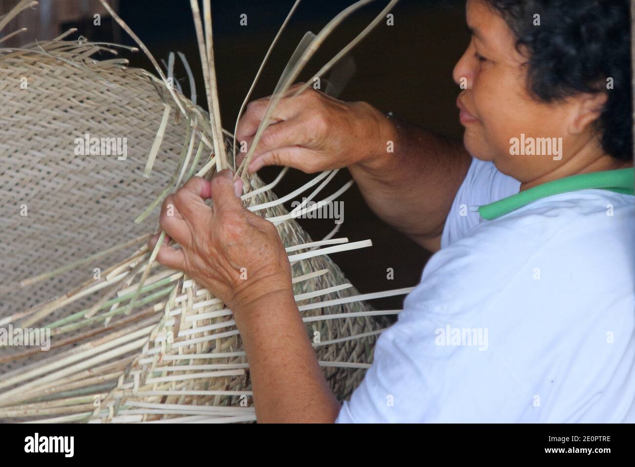 Malaysia, Sarawak, bidahyu women sitting inside long house weaving a ...