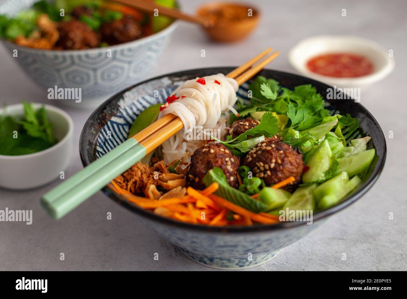 Side view of a Vietnamese bowl of rice noodles with vegetables and