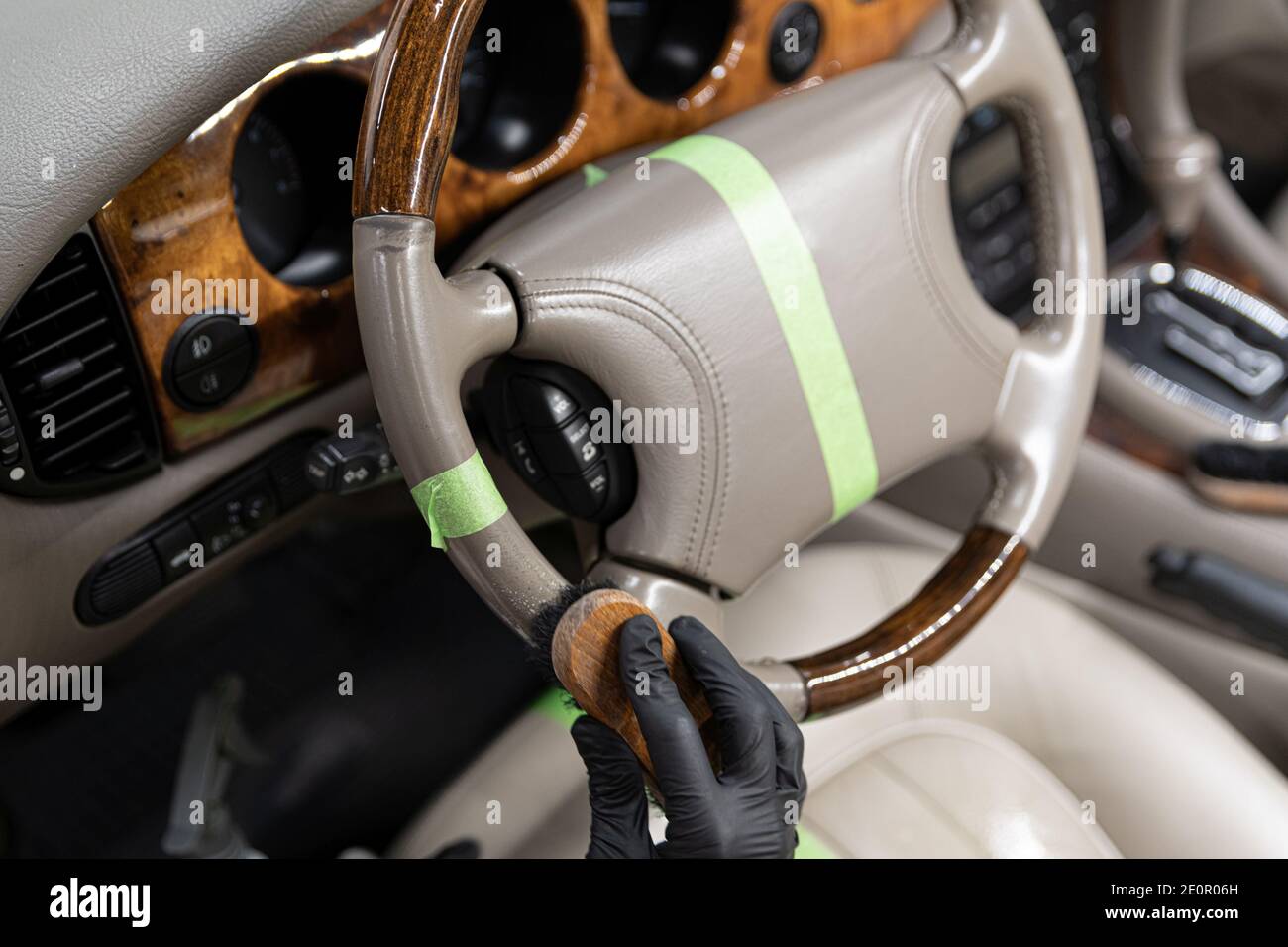 Worker cleaning and renovating leather steering wheel Stock Photo Alamy