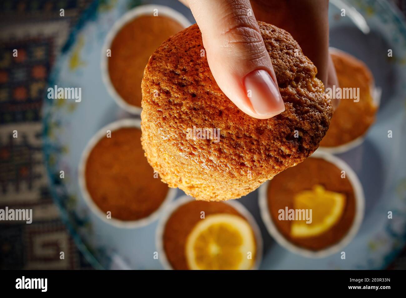 Girl holding fresh cupcake in her hand Stock Photo