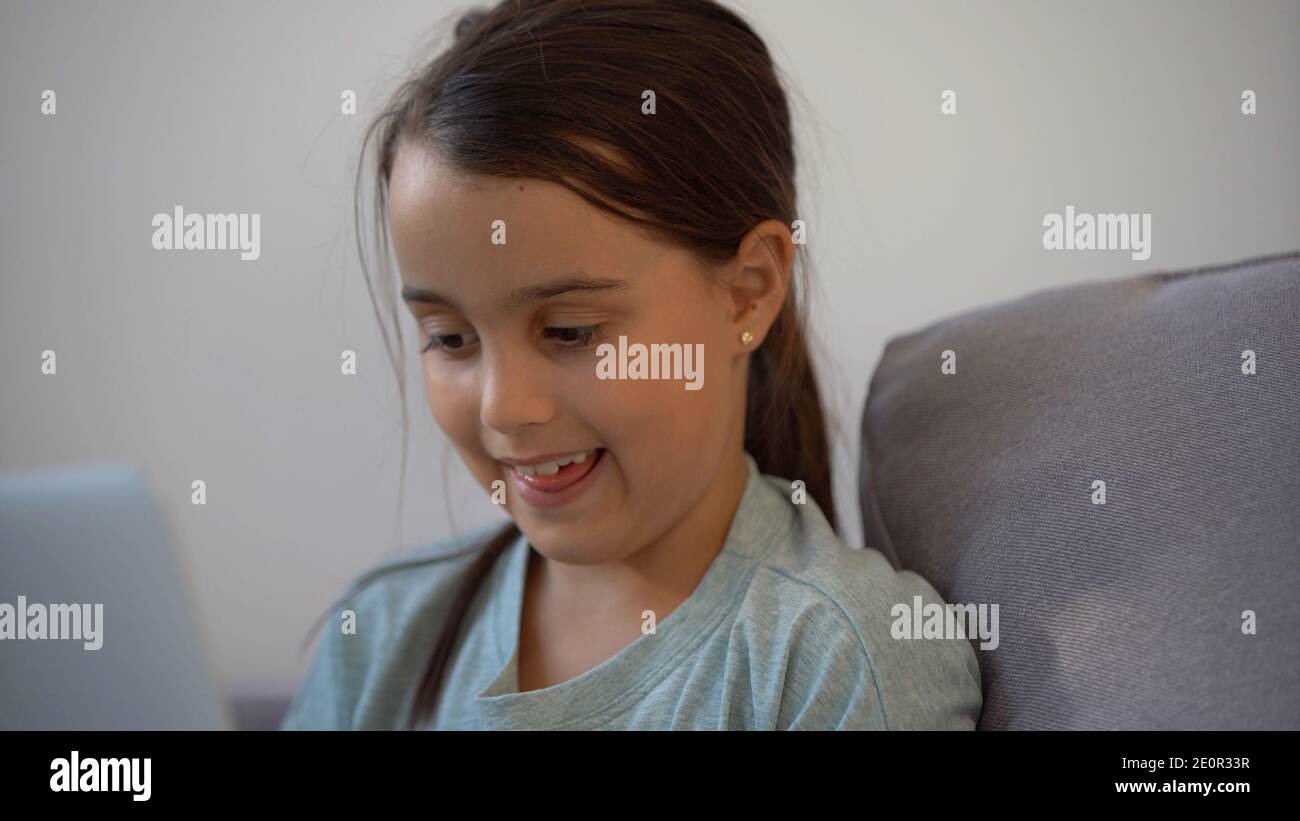 Cute little girl using laptop at home. Education, online study, home ...