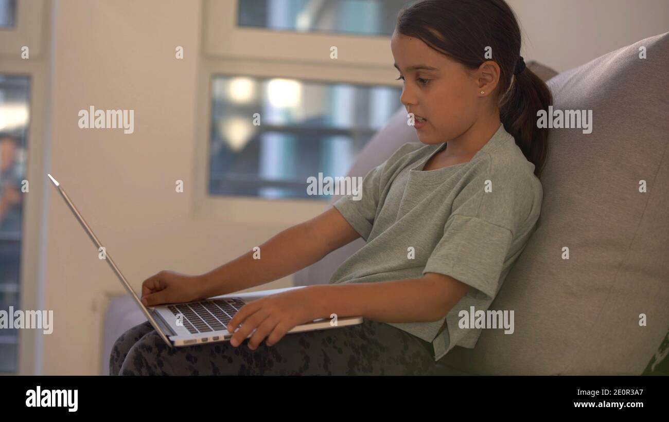 Cute little girl using laptop at home. Education, online study, home ...