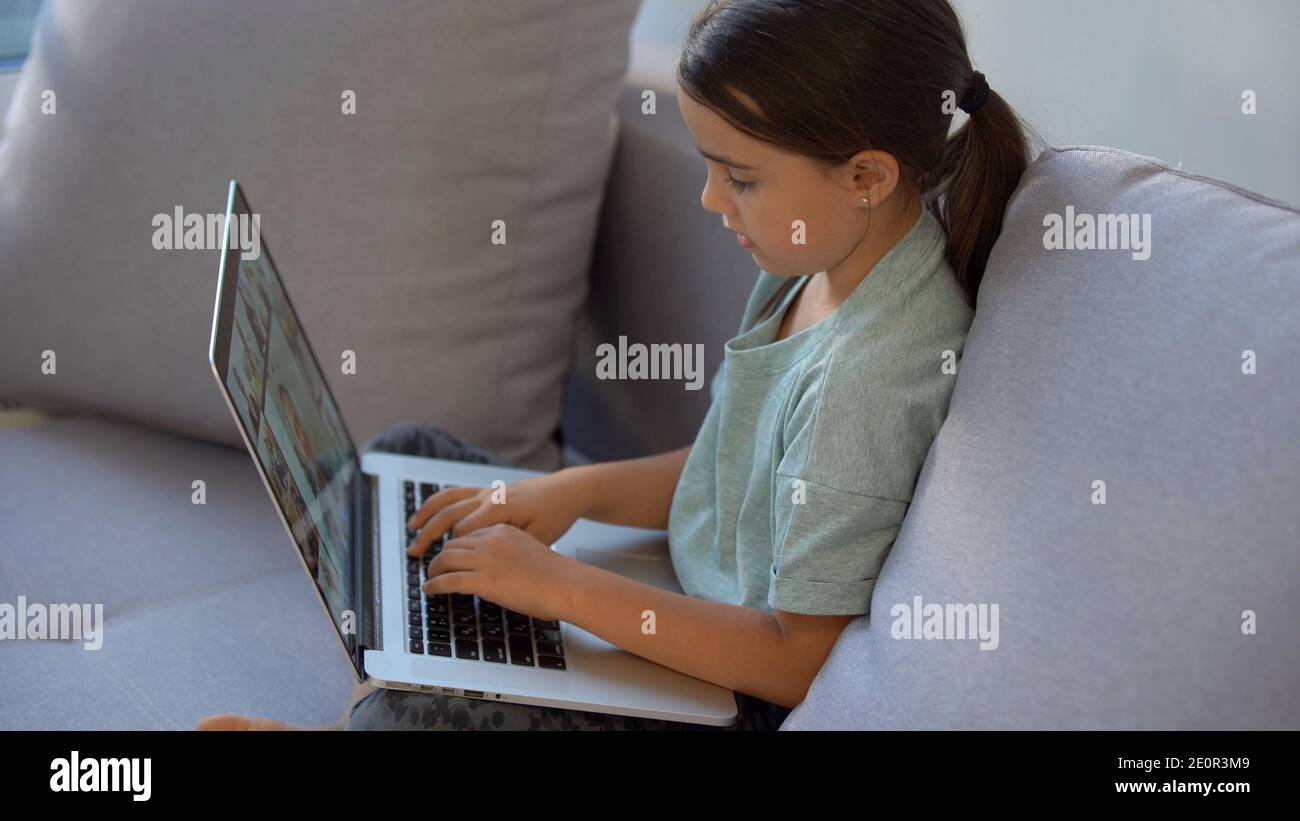 Cute little girl using laptop at home. Education, online study, home ...