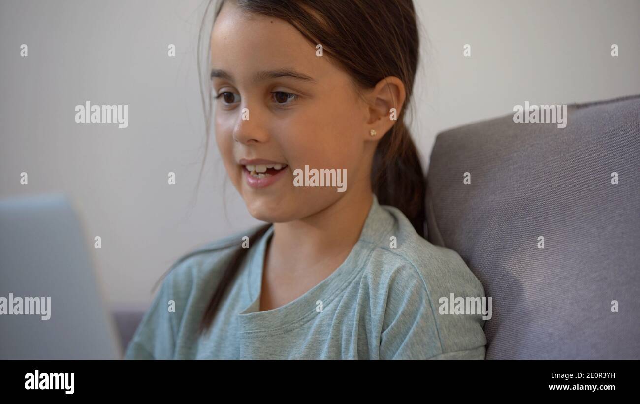 Cute little girl using laptop at home. Education, online study, home ...