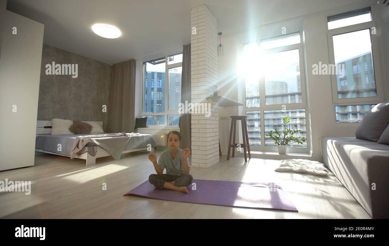 little cute girl do a yoga at home with space for add text Stock Photo ...