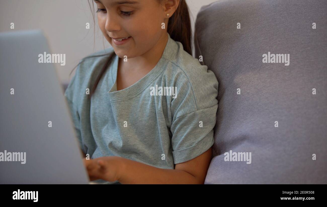 Cute little girl using laptop at home. Education, online study, home ...