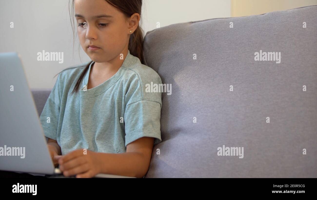 Cute little girl using laptop at home. Education, online study, home ...