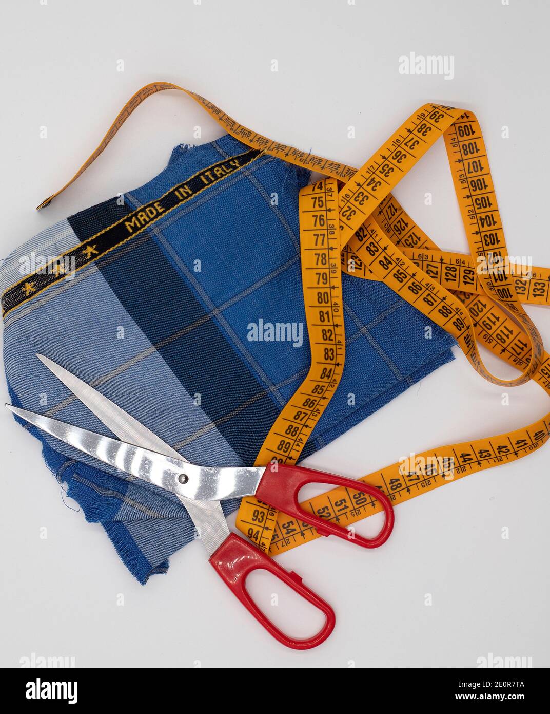 Scissors and made in Italy fabric on white background Stock Photo