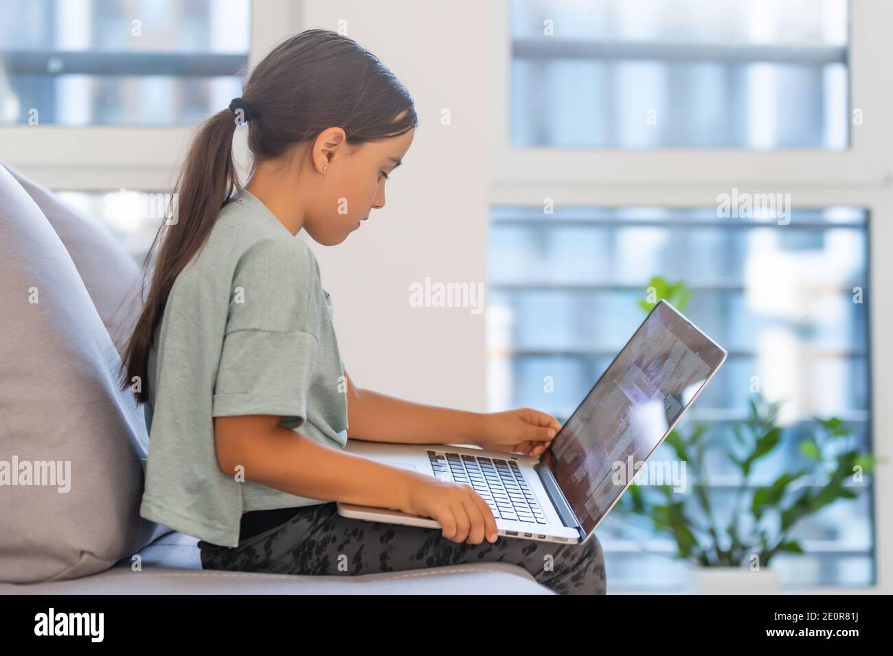 Cute little girl using laptop at home. Education, online study, home ...