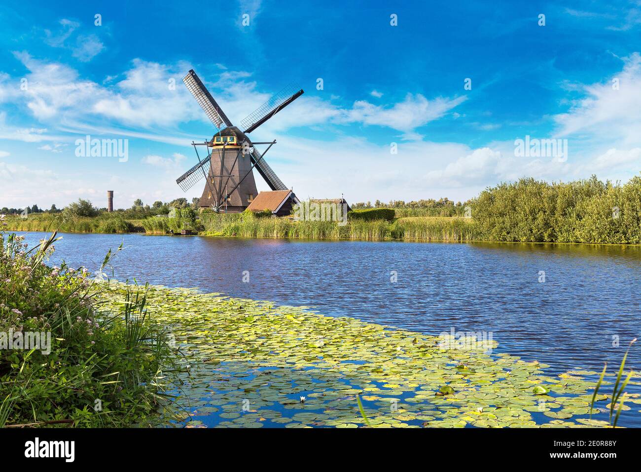 Windmills And Water Canal In Kinderdijk In A Beautiful Summer Day Windmills And Water Canal In Kinderdijk In A Beautiful Summer Day