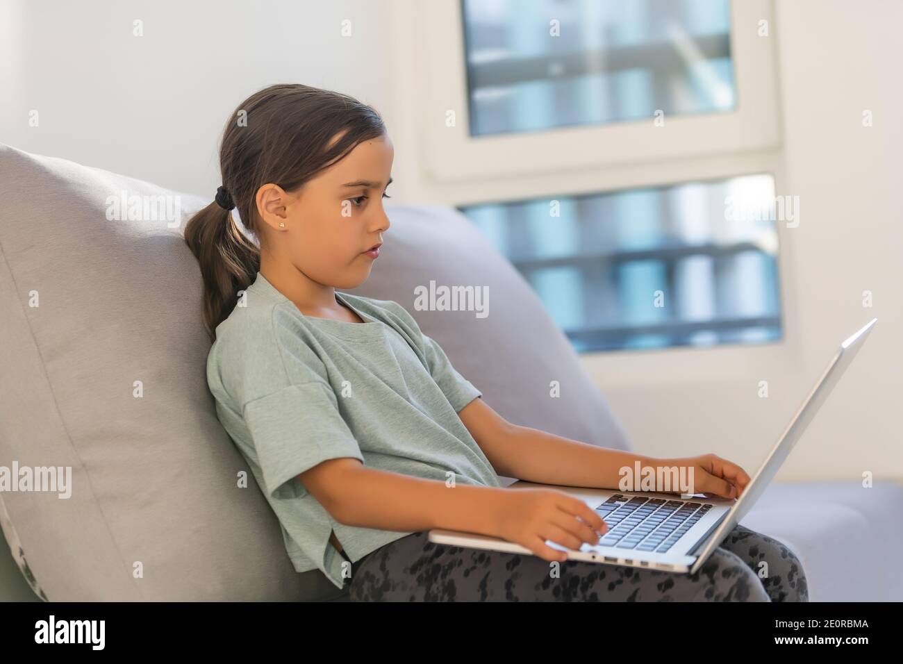 Cute little girl using laptop at home. Education, online study, home ...