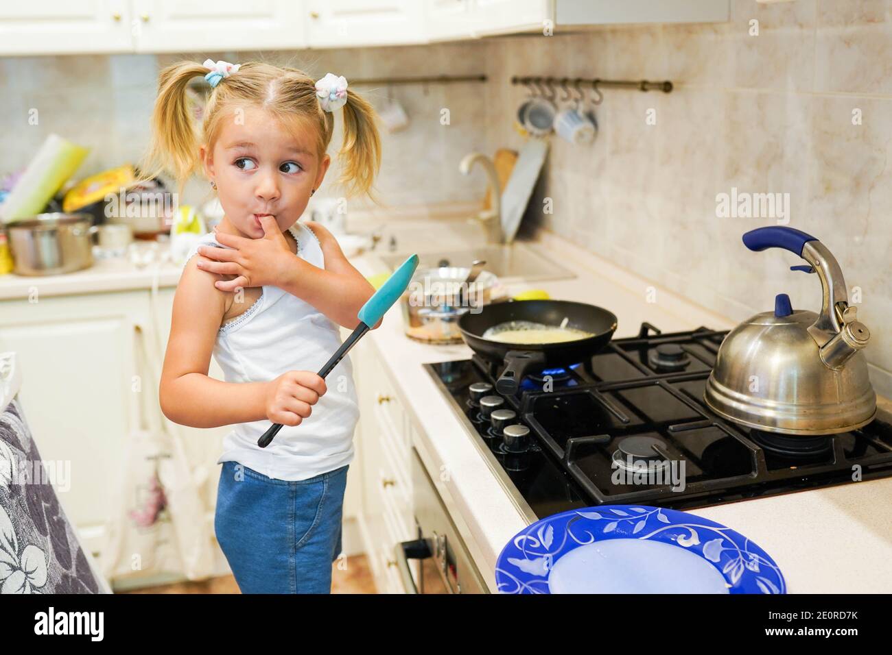 Cute little girl prepare pancakes in the kitchen Stock Photo Alamy