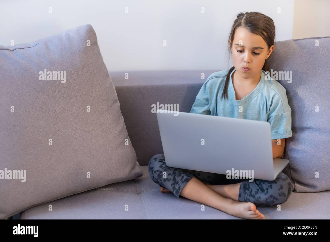 Cute little girl using laptop at home. Education, online study, home ...