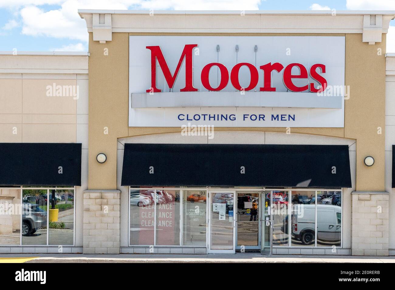 Sign in the facade of a Moores branded store. The chain specializes in selling men's clothing. There are no people in the color scene Stock Photo