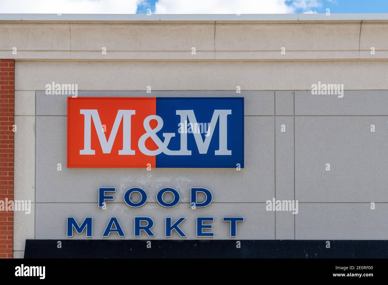 Sign on the facade of an M&M Food Market. The image is a close up with no people on it Stock Photo