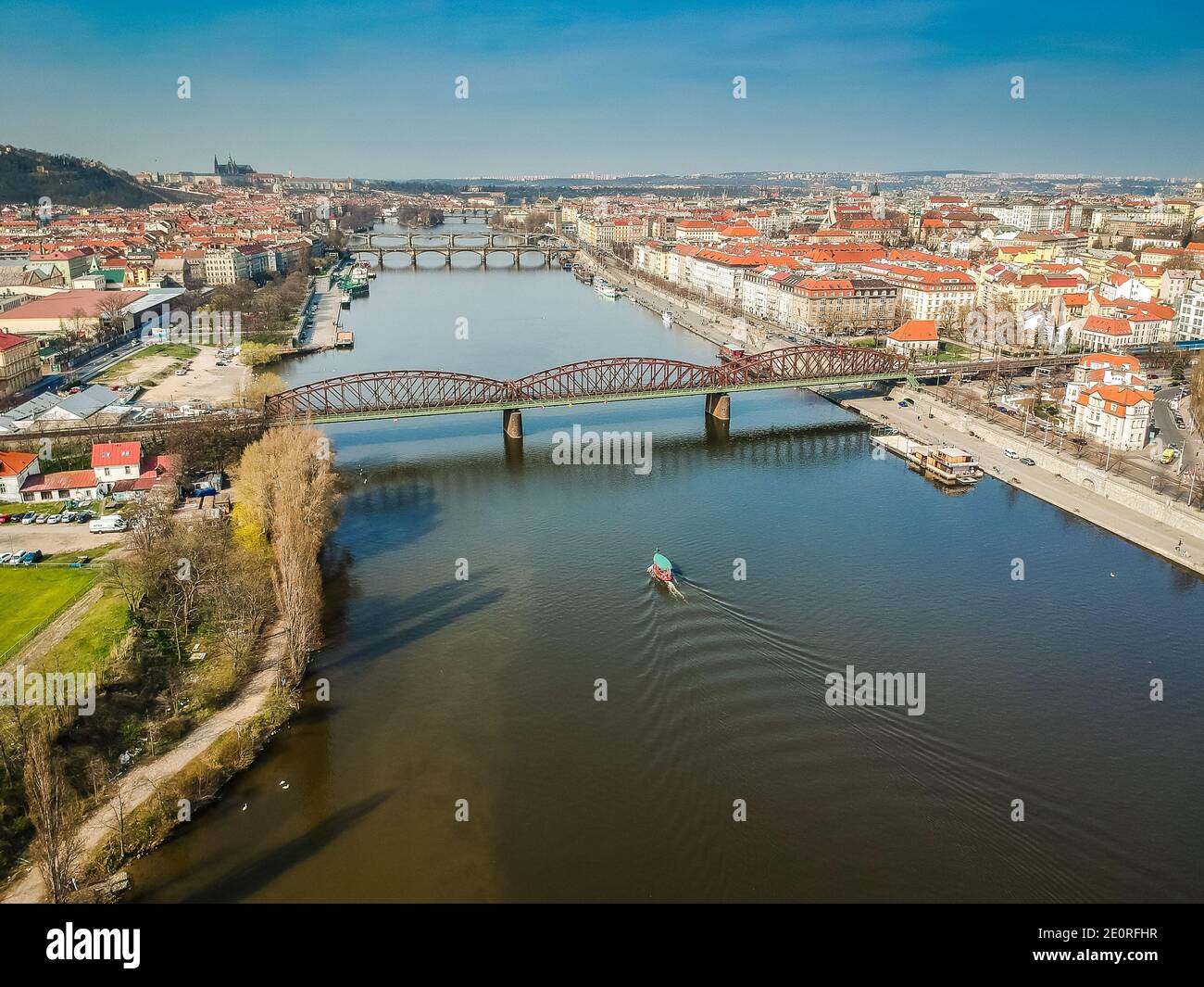 Railway bridge between Vyton and Smichov area above Moldau river with other bridges, Old Town and Prague Castle in background Stock Photo