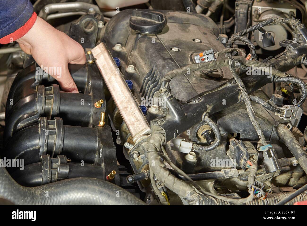 Car engine repair, intake manifold, connection of LPG injectors Stock