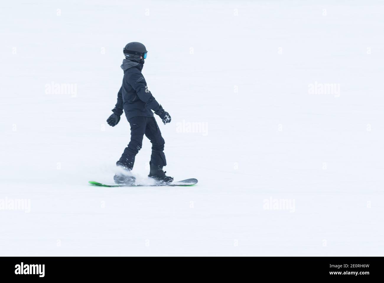 A snowboarder goes down the slopes of Niseko, in Hokkaido, Japan. Stock Photo