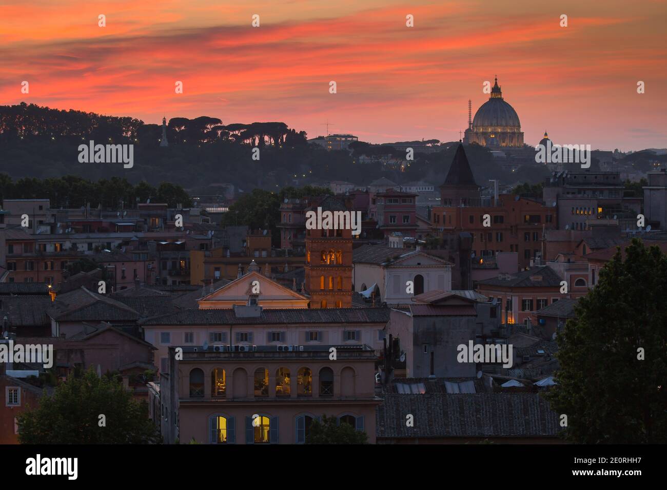 Panoramic colorful view of Rome at sunset. City skyline with Saint Peter Basilica in the background in a summer evening, Rome, Italy Stock Photo