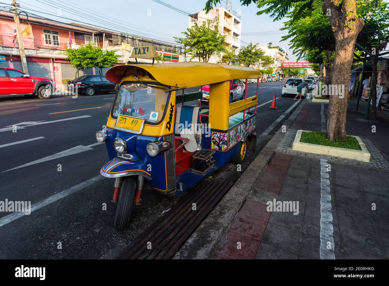 A tuk-tuk is parked on a street near Wat Arun, in Bangkok, Thailand Stock Photo