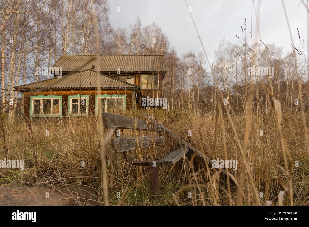 Old wood bench next to a path Stock Photo - Alamy