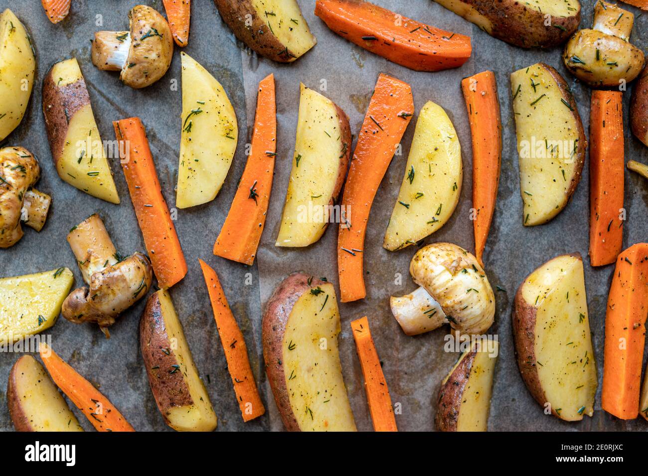 restaurant, vegetarianism, fast, healthy food, recipes concepts - raw cut potatoes carrots, mushrooms with seasoning dill. fresh marinated vegetables Stock Photo