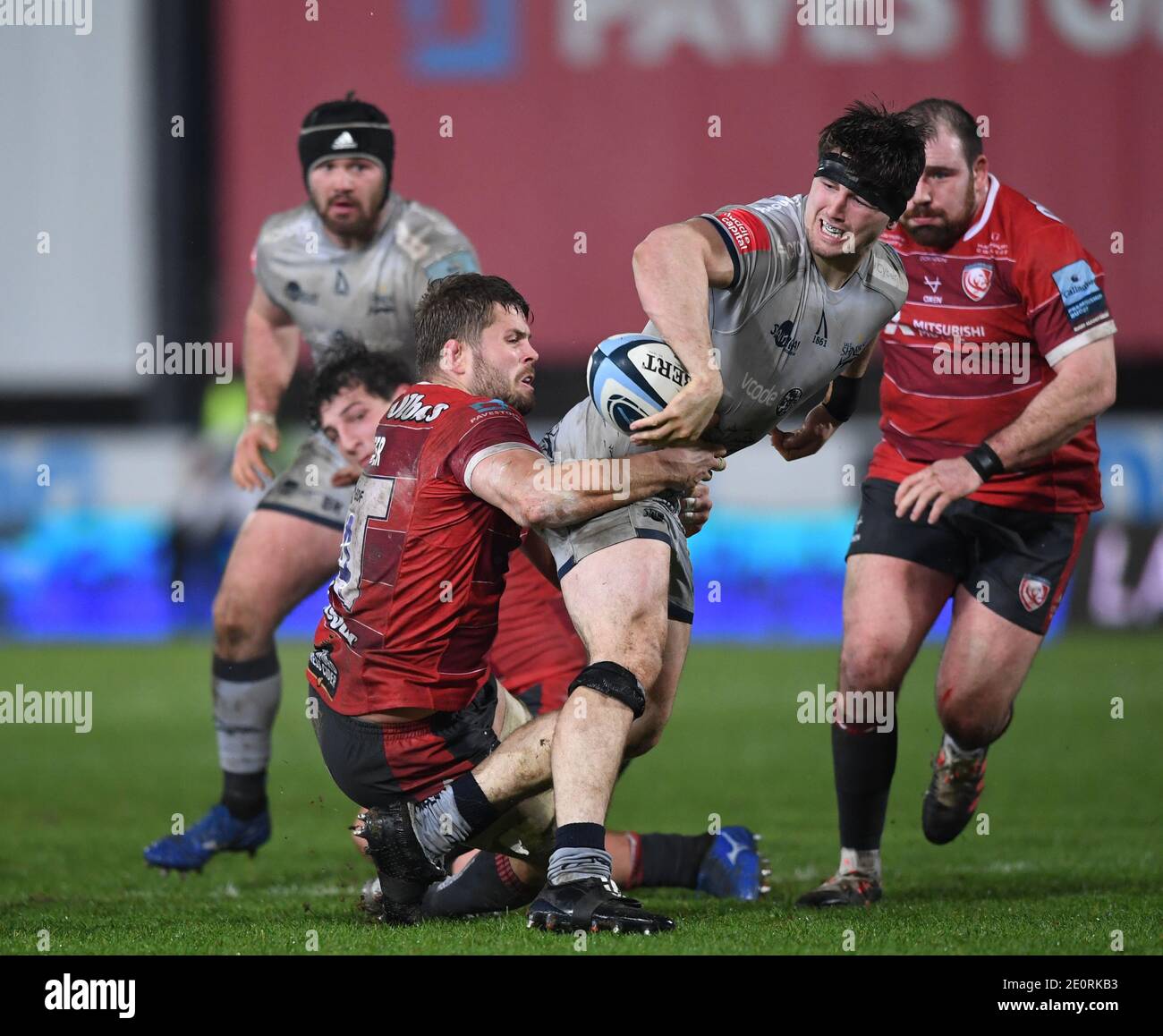 Kingsholm Stadium, Gloucester, Gloucestershire, UK. 2nd Jan, 2021. English Premiership Rugby, Gloucester versus Sale Sharks; Tom Curry of Sale Sharks offloads out of the tackle from Ed Slater of Gloucester Credit: Action Plus Sports/Alamy Live News Stock Photo