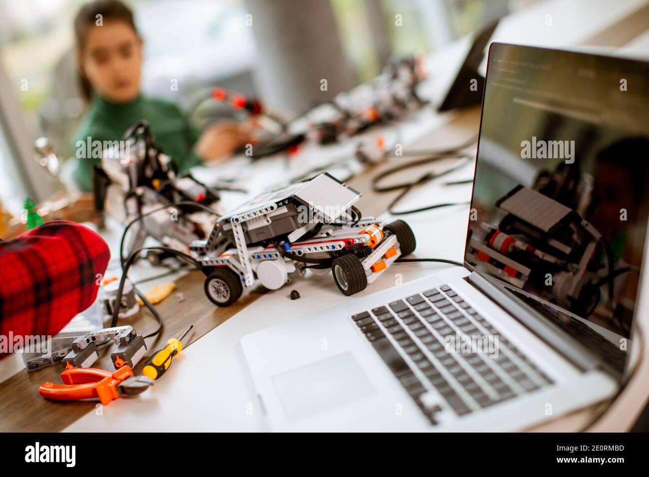 Group of happy kids programming electric toys and robots at robotics ...