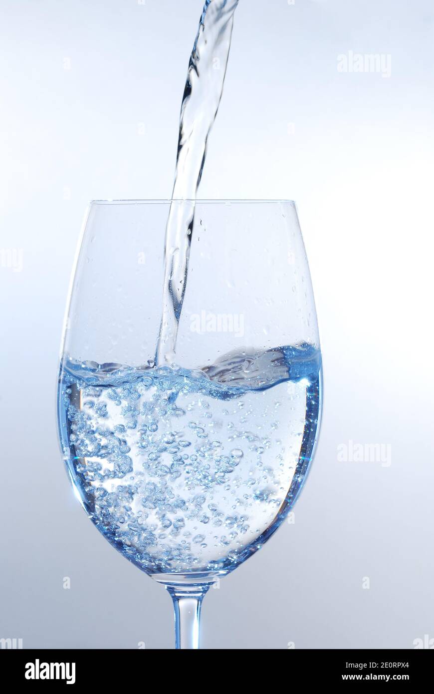 clear transparent water pour into wineglass Stock Photo - Alamy