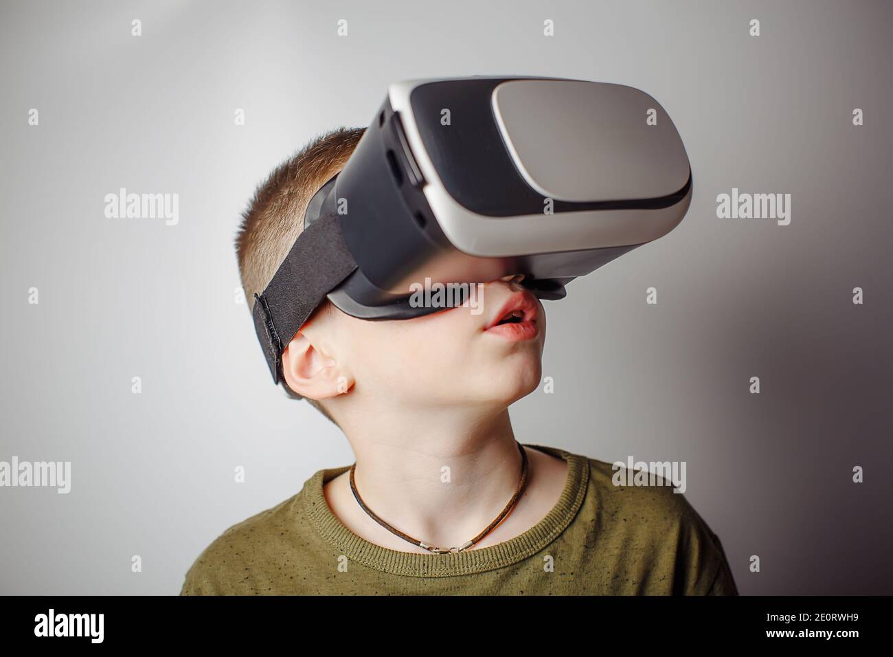 Boy playing mobile game app on device virtual reality glasses on white  background. Boy action and using in virtual headset, VR box for use with  smart Stock Photo - Alamy