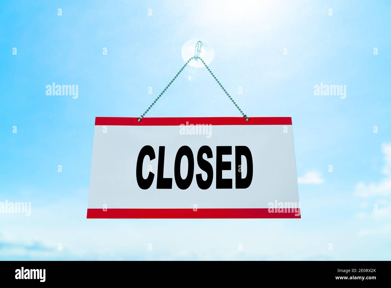 CLOSED SIGN hanging at retail business storefront window after COVID-19 lockdown. Bankruptcy and unemployment in the aftermath of the corona virus Stock Photo