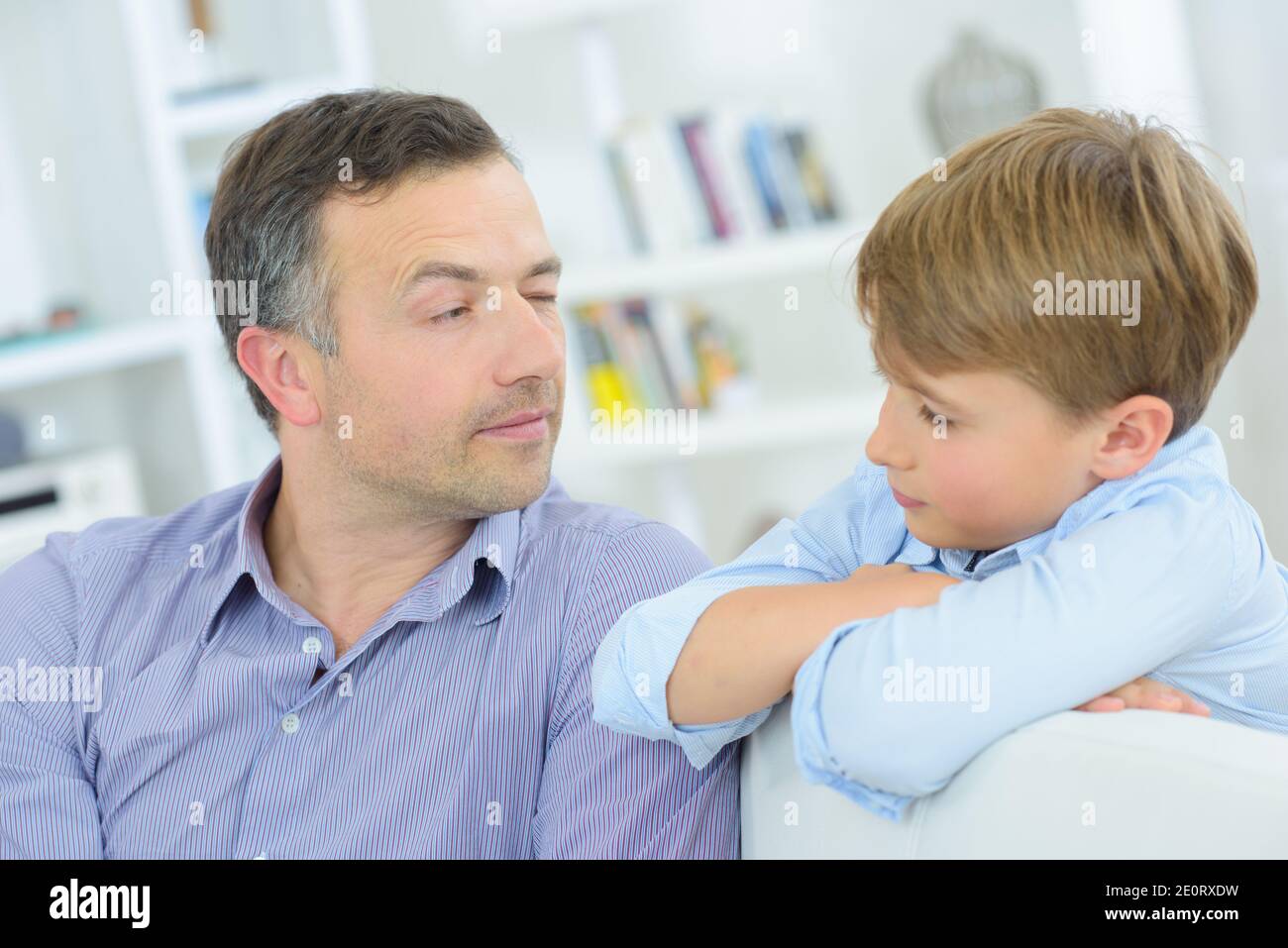 Father looking at son out of the corner of his eye Stock Photo