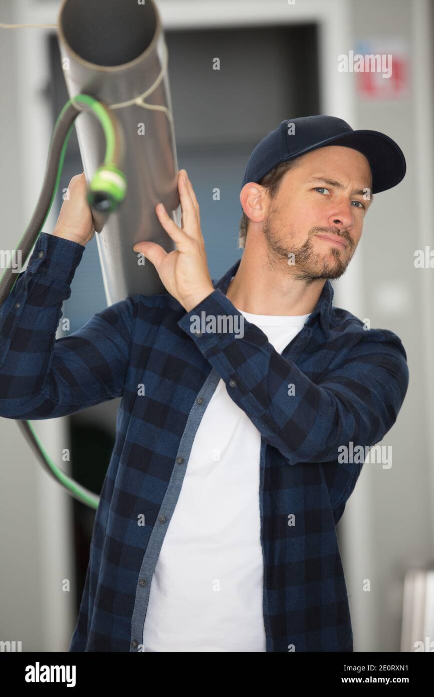 man holding the pvc pipe Stock Photo - Alamy